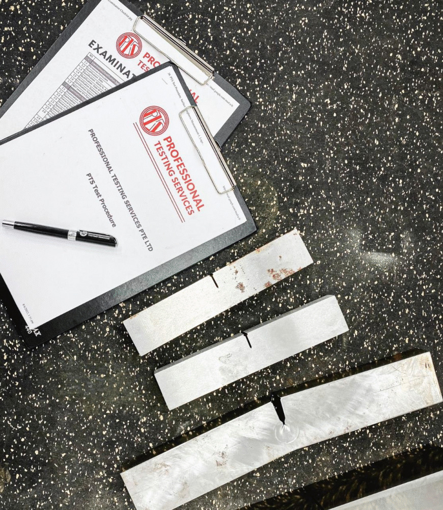 A clipboard next to a material sample, subjected to a crack-tip opening displacement test.