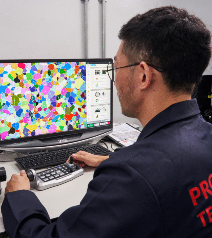 metallurgist performing grain size analysis according to image captured on a microsope