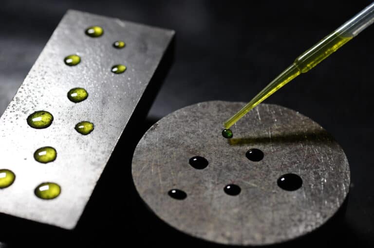 A chemical surface test solution applied to stainless steel samples to detect iron contamination.