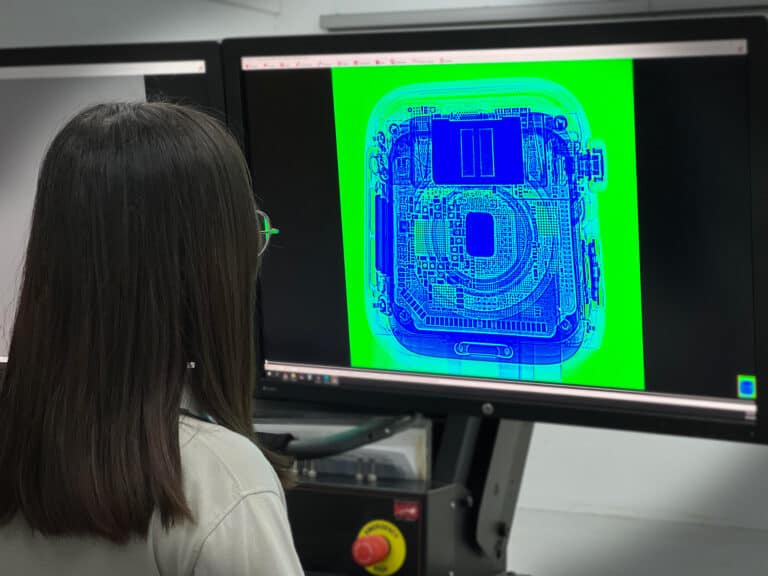 A PTS engineer checking the digital radiography results of a sample on a screen.