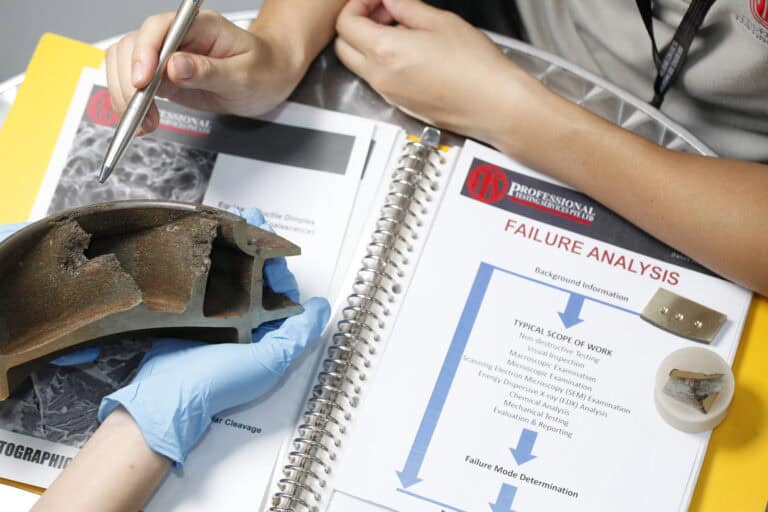 A PTS engineer analysing material microstructure for failure investigation.