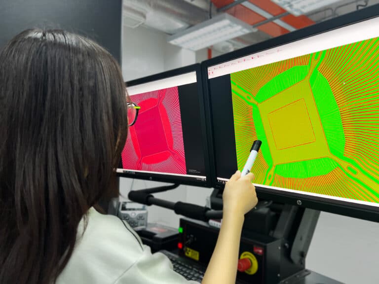 An engineer reviewing 2D digital radiography inspection results on a workstation screen.