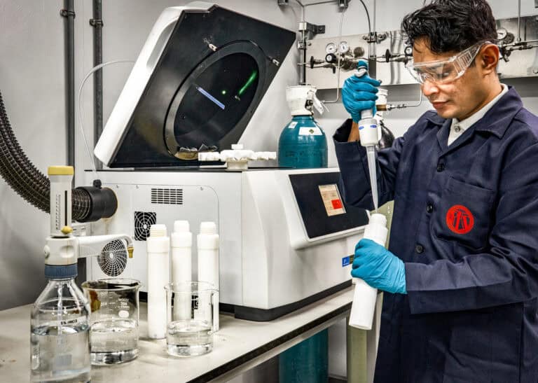 A PTS engineer using a 3D X-ray computed tomography scanning chamber for industrial inspection.